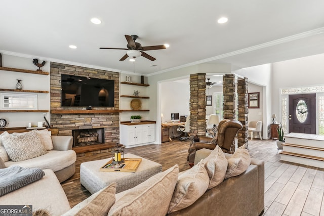 2624 E Madison Dr, Atlanta, GA 30360 - living area featuring ceiling fan, decorative columns, crown molding, a fireplace, and light wood-type flooring