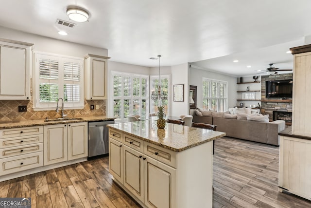 2624 E Madison Dr, Atlanta, GA 30360 - kitchen featuring cream cabinets, stainless steel dishwasher, a sink, wood finished floors, and recessed lighting