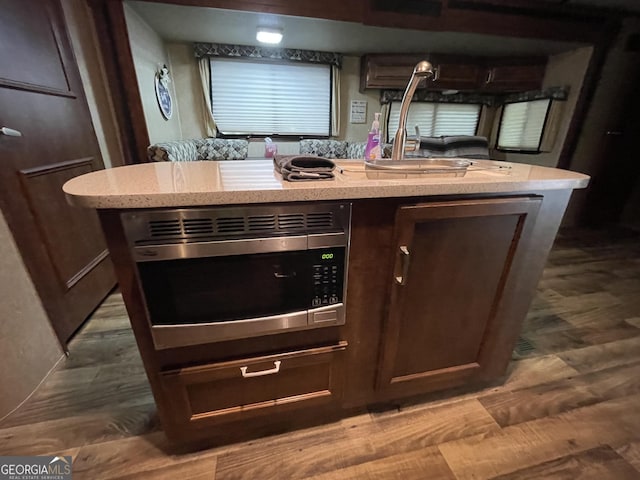 54 Candy Land Dr, Cleveland, GA 30528 - kitchen with a sink, stainless steel microwave, wood finished floors, and light stone countertops