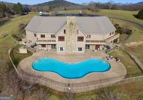 54 Candy Land Dr, Cleveland, GA 30528 - outdoor pool featuring stairway, a patio area, and a mountain view