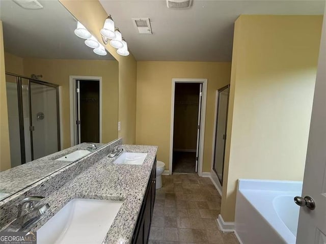 102 Daisy Cir, Mcdonough, GA 30252 - bathroom with a stall shower, a spacious closet, baseboards, and double vanity