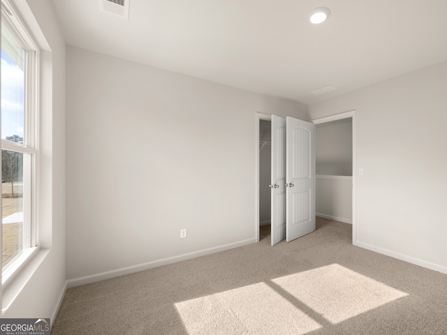 525 King Vlg, Braselton, GA 30517 - unfurnished bedroom featuring light carpet and baseboards