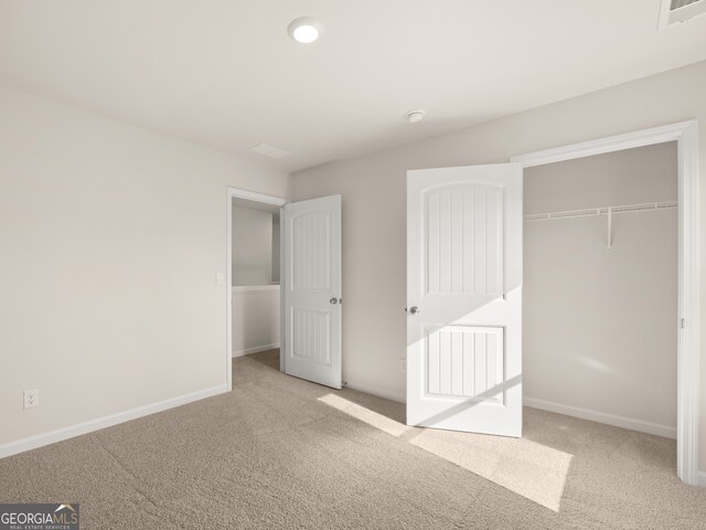 525 King Vlg, Braselton, GA 30517 - unfurnished bedroom featuring carpet flooring, a closet, and baseboards