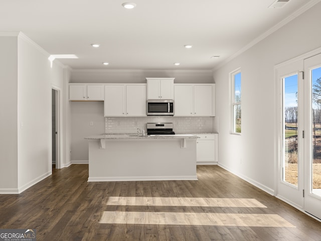 525 King Vlg, Braselton, GA 30517 - kitchen featuring appliances with stainless steel finishes, backsplash, white cabinets, ornamental molding, and a sink