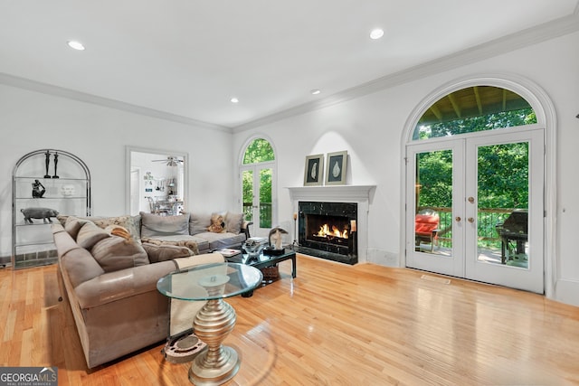 5105 Jett Forest Trl NW, Sandy Springs, GA 30327 - living area featuring french doors, ornamental molding, wood finished floors, a high end fireplace, and recessed lighting