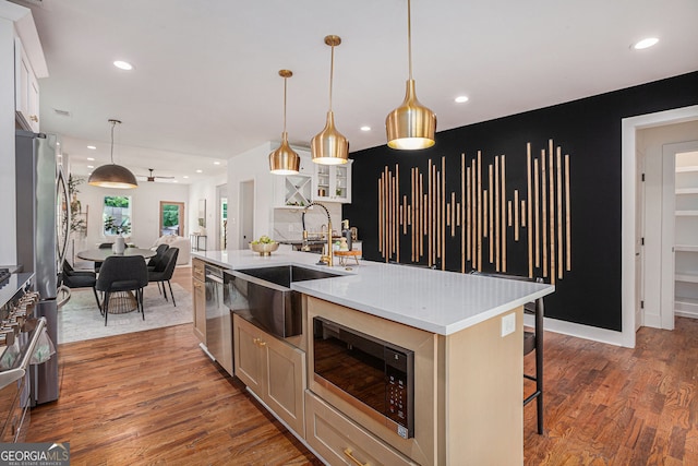 1721 S Gordon St SW, Atlanta, GA 30310 - kitchen with stainless steel appliances, light wood-style flooring, open floor plan, light countertops, and a center island with sink