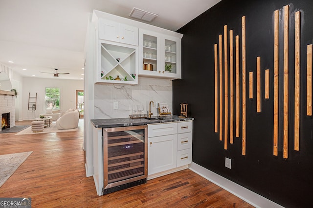 1721 S Gordon St SW, Atlanta, GA 30310 - indoor wet bar with wine cooler, wood finished floors, ceiling fan, a brick fireplace, and recessed lighting