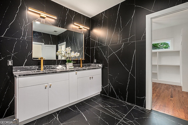 1721 S Gordon St SW, Atlanta, GA 30310 - full bathroom featuring tile walls, double vanity, stone wall, and marble tiled floors