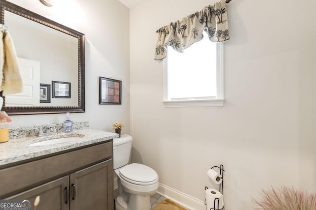 128 Arbor Crk, Warner Robins, GA 31093 - half bathroom featuring toilet, vanity, and baseboards