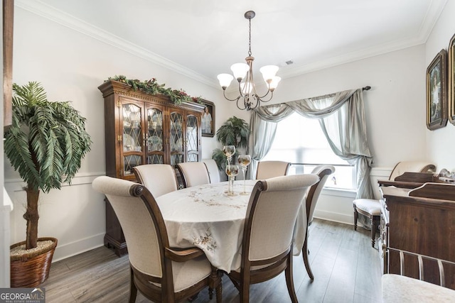 128 Arbor Crk, Warner Robins, GA 31093 - dining space featuring a chandelier, ornamental molding, wood finished floors, and baseboards