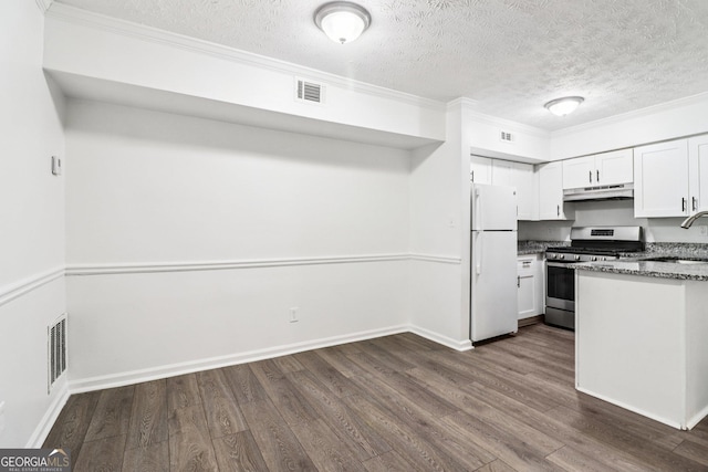1931 Brian Way, Decatur, GA 30033 - kitchen with freestanding refrigerator, stainless steel gas stove, under cabinet range hood, dark wood-type flooring, and a textured ceiling
