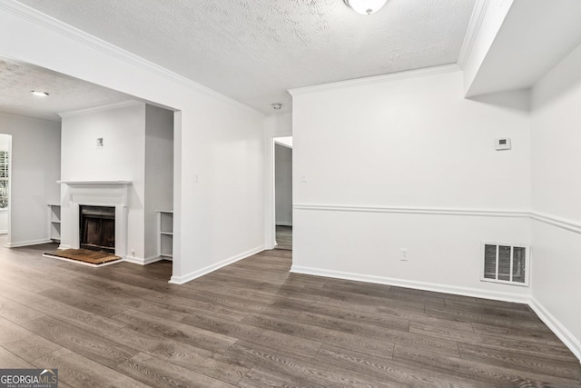 1931 Brian Way, Decatur, GA 30033 - unfurnished living room with wood finished floors, a textured ceiling, ornamental molding, and a fireplace with raised hearth