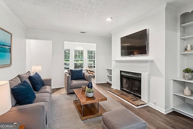 1931 Brian Way, Decatur, GA 30033 - living room with wood finished floors, ornamental molding, a fireplace with raised hearth, and built in shelves