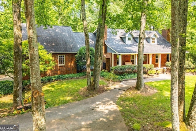 3187 Oak Grove Church Rd, Carrollton, GA 30117 - new england style home with brick siding, a front yard, and roof with shingles
