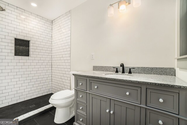 2695 Peeler Rd, Dunwoody, GA 30360 - bathroom with vanity, tiled shower, toilet, and tile patterned floors
