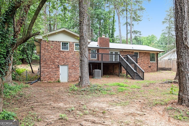 2695 Peeler Rd, Dunwoody, GA 30360 - back of property with brick siding, stairway, a chimney, a wooden deck, and cooling unit
