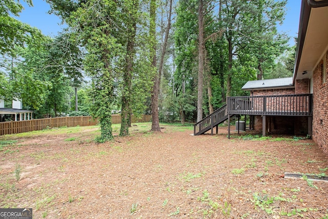 2695 Peeler Rd, Dunwoody, GA 30360 - view of yard with stairway, a wooden deck, and central AC unit
