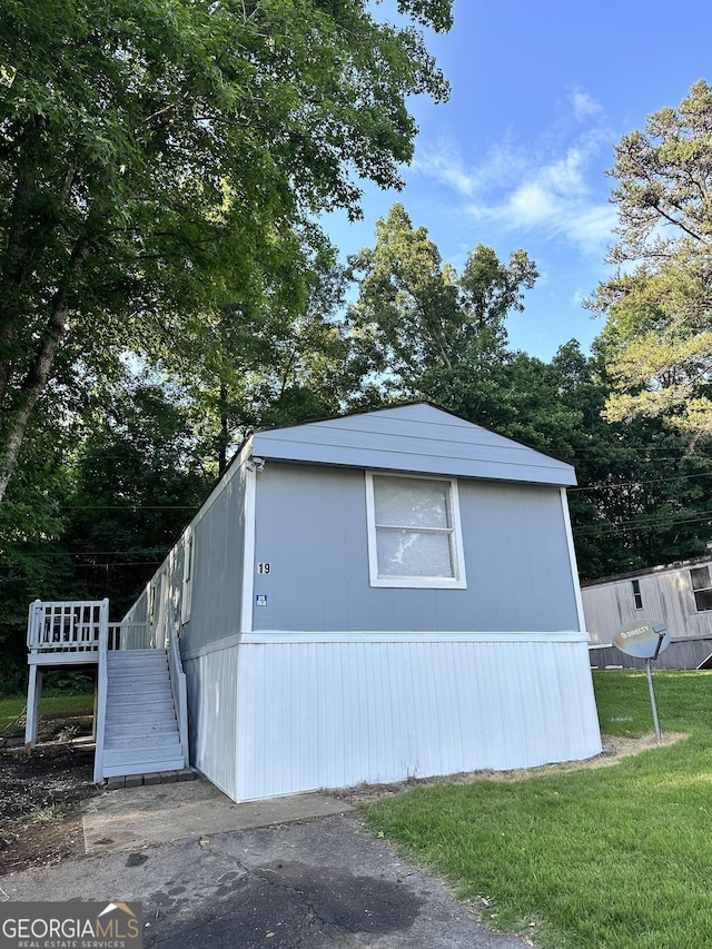 19 Poole Cir, Ellenwood, GA 30294 - view of side of home featuring stairway and a yard