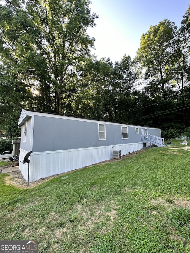19 Poole Cir, Ellenwood, GA 30294 - view of property exterior with a lawn and central AC unit