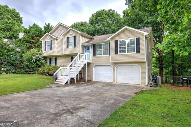 62 Lazy Water Dr SW, Cartersville, GA 30120 - tri-level home featuring an attached garage, driveway, and view of scattered trees