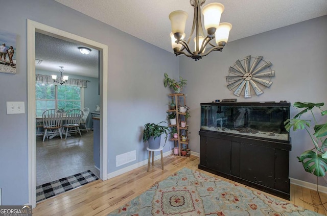 62 Lazy Water Dr SW, Cartersville, GA 30120 - dining area featuring a chandelier, wood finished floors, and a textured ceiling