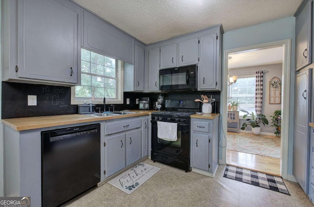 62 Lazy Water Dr SW, Cartersville, GA 30120 - kitchen with black appliances, tasteful backsplash, gray cabinetry, and a textured ceiling