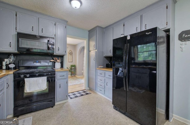 62 Lazy Water Dr SW, Cartersville, GA 30120 - kitchen featuring black appliances, arched walkways, gray cabinets, and a textured ceiling