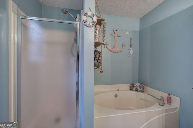 62 Lazy Water Dr SW, Cartersville, GA 30120 - full bathroom with a textured ceiling, a stall shower, and a bath