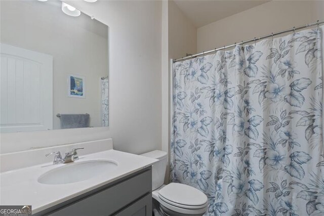 5755 Turnstone Trl, Flowery Branch, GA 30542 - bathroom featuring vanity, toilet, and a shower with curtain