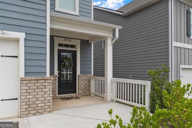 5755 Turnstone Trl, Flowery Branch, GA 30542 - entrance to property featuring covered porch and a garage