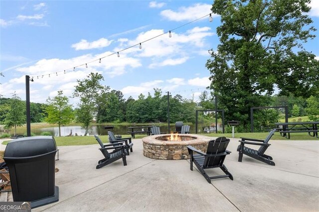 5755 Turnstone Trl, Flowery Branch, GA 30542 - view of patio with an outdoor fire pit, a water view, and view of wooded area