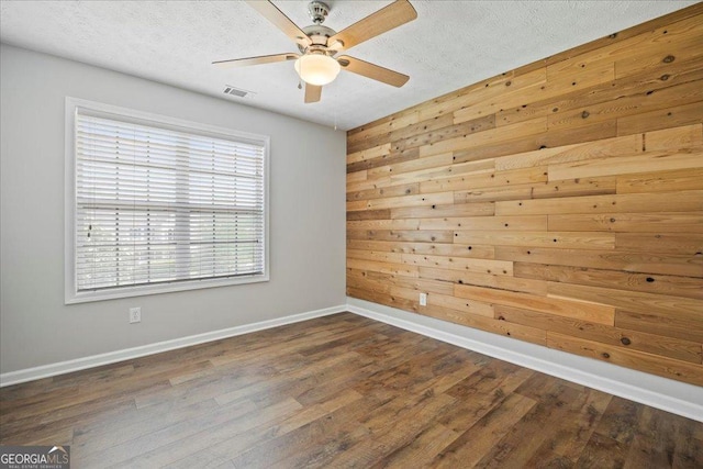 7825 Running Fox Trl, Gainesville, GA 30506 - spare room featuring a ceiling fan, wood finished floors, a textured ceiling, and wood walls