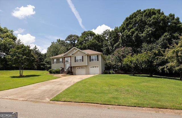 7825 Running Fox Trl, Gainesville, GA 30506 - bi-level home featuring a garage, a front yard, concrete driveway, and view of scattered trees