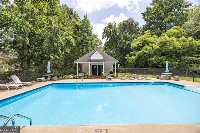 7825 Running Fox Trl, Gainesville, GA 30506 - community pool featuring a patio area, view of wooded area, and an outdoor structure