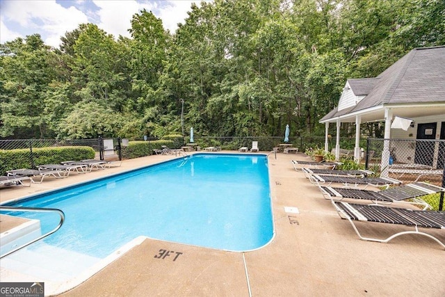 7825 Running Fox Trl, Gainesville, GA 30506 - community pool featuring a patio area and view of wooded area