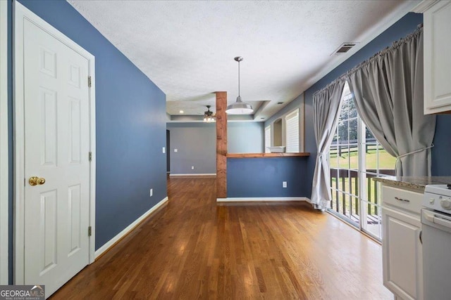 7825 Running Fox Trl, Gainesville, GA 30506 - unfurnished dining area featuring a ceiling fan, wood finished floors, and a textured ceiling