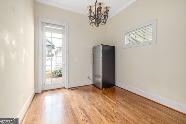 311 Vinings Walk, Gainesville, GA 30501 - unfurnished dining area with crown molding, plenty of natural light, a chandelier, and light wood-type flooring