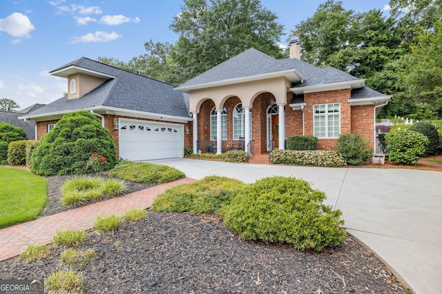 311 Vinings Walk, Gainesville, GA 30501 - view of front of house with brick siding, driveway, a shingled roof, a chimney, and a garage