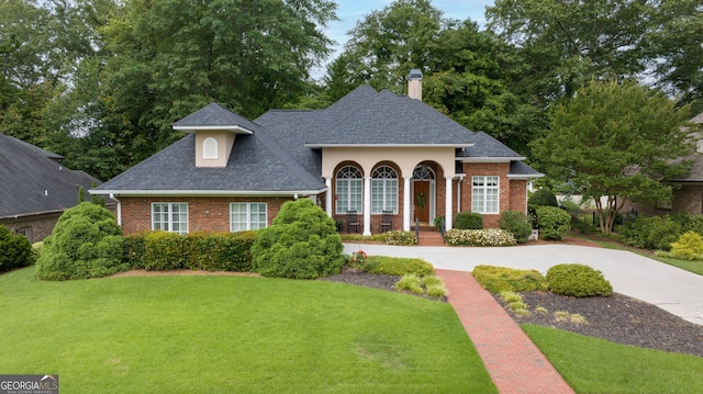 311 Vinings Walk, Gainesville, GA 30501 - view of front facade with brick siding, a chimney, a front yard, and a shingled roof