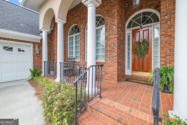 311 Vinings Walk, Gainesville, GA 30501 - property entrance featuring brick siding, covered porch, an attached garage, and a shingled roof