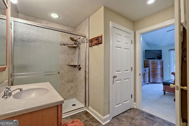 4505 Mccullum Trl, Hiawassee, GA 30546 - bathroom featuring a stall shower, vanity, connected bathroom, baseboards, and tile patterned flooring