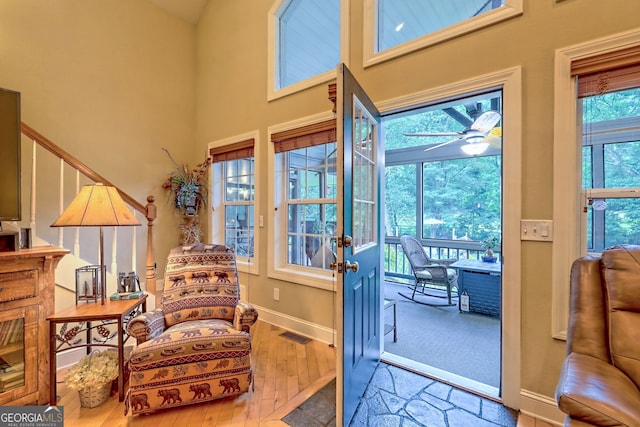 4505 Mccullum Trl, Hiawassee, GA 30546 - sitting room with hardwood / wood-style floors, a towering ceiling, baseboards, and ceiling fan