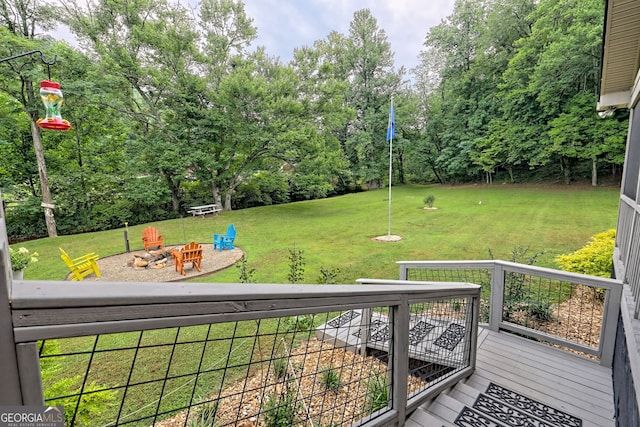 4505 Mccullum Trl, Hiawassee, GA 30546 - view of grassy yard with a fire pit, view of wooded area, and a deck