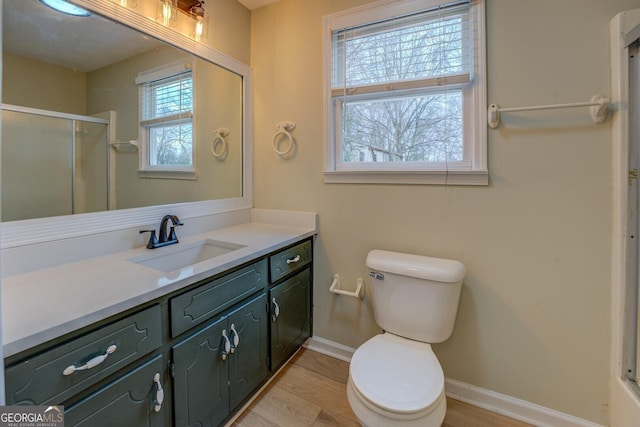 4131 Carroll St SW, Covington, GA 30014 - bathroom featuring vanity, a shower with shower door, and wood finished floors