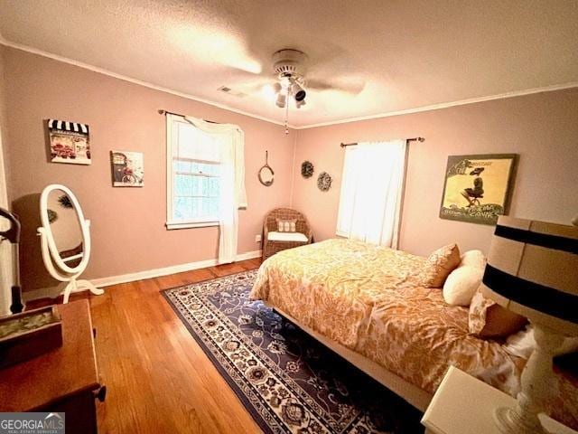 315 Clairborne Ave, Statesboro, GA 30458 - bedroom with ornamental molding, wood finished floors, baseboards, and ceiling fan