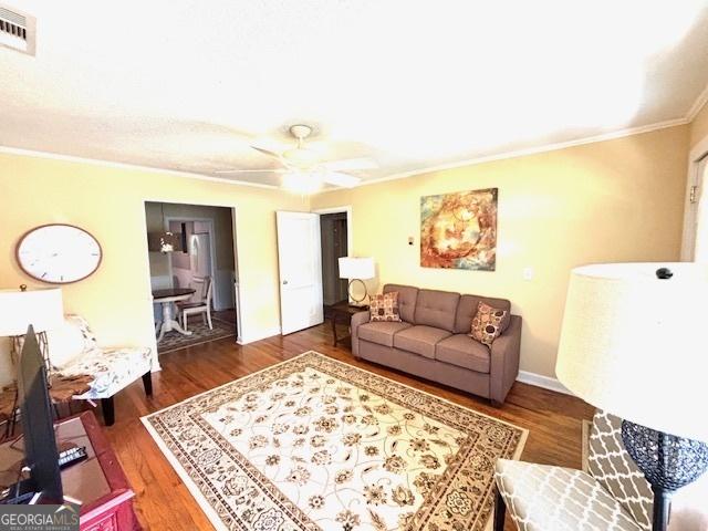 315 Clairborne Ave, Statesboro, GA 30458 - living room with crown molding, wood finished floors, and a ceiling fan