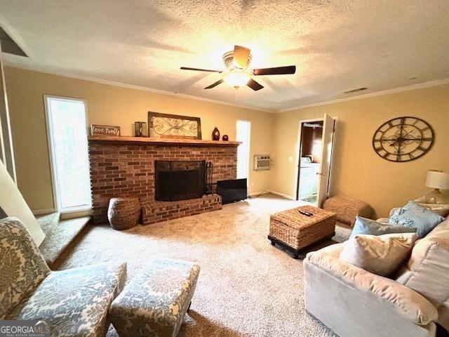 315 Clairborne Ave, Statesboro, GA 30458 - living area with a ceiling fan, carpet flooring, a textured ceiling, a brick fireplace, and a wall mounted air conditioner