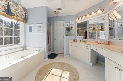 154 Hunters Trl, Dallas, GA 30157 - full bathroom featuring a ceiling fan, a shower stall, double vanity, and a bath