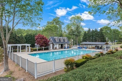 154 Hunters Trl, Dallas, GA 30157 - community pool with a pergola and view of wooded area