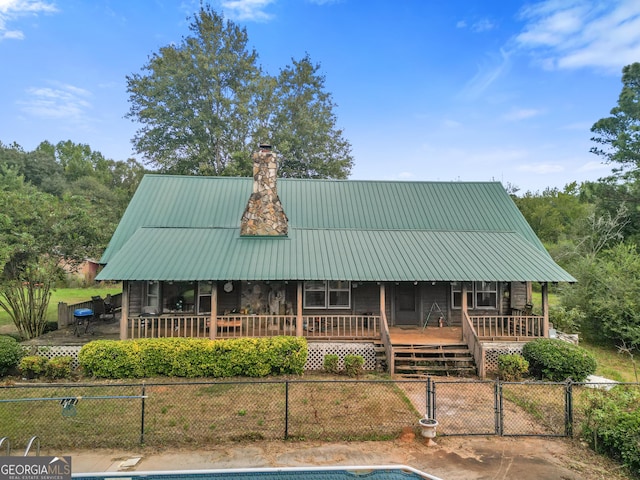 223 Arthur Rd, Zebulon, GA 30295 - view of front of house featuring covered porch, a chimney, a gate, and metal roof